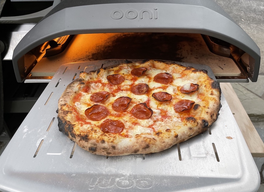 Pepperoni pizza coming out of an Ooni oven